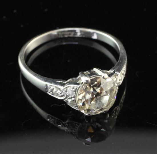 An 18ct white gold and platinum single stone diamond ring with diamond set shoulders, size M.